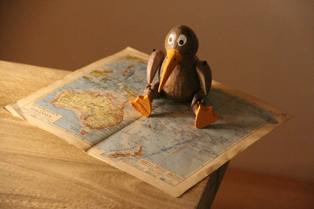 Notebook, hand-drawn map and magnifying glass on a table